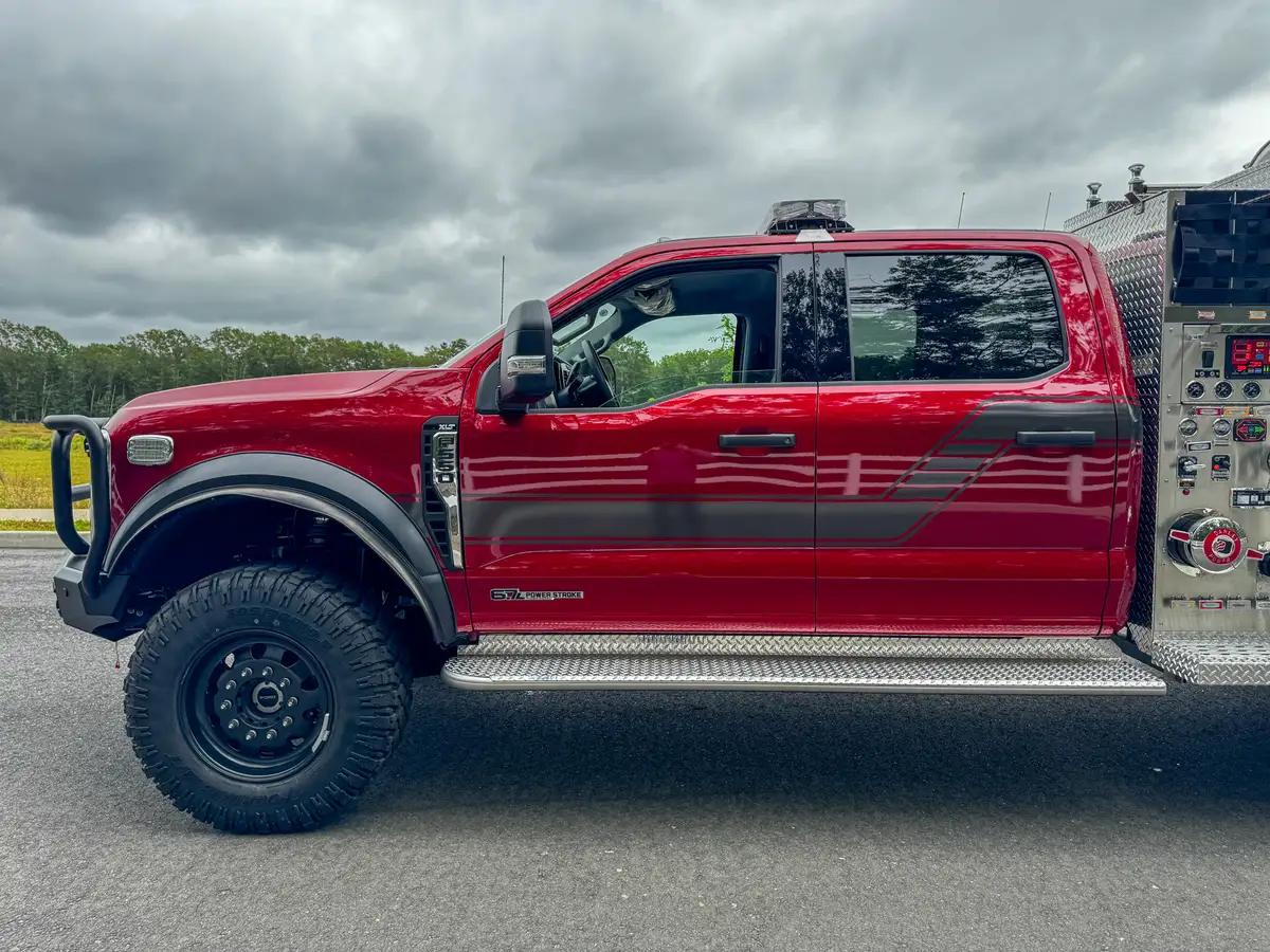Right-side crew-cab profile with front fender, rear body, and pump-panel edge.